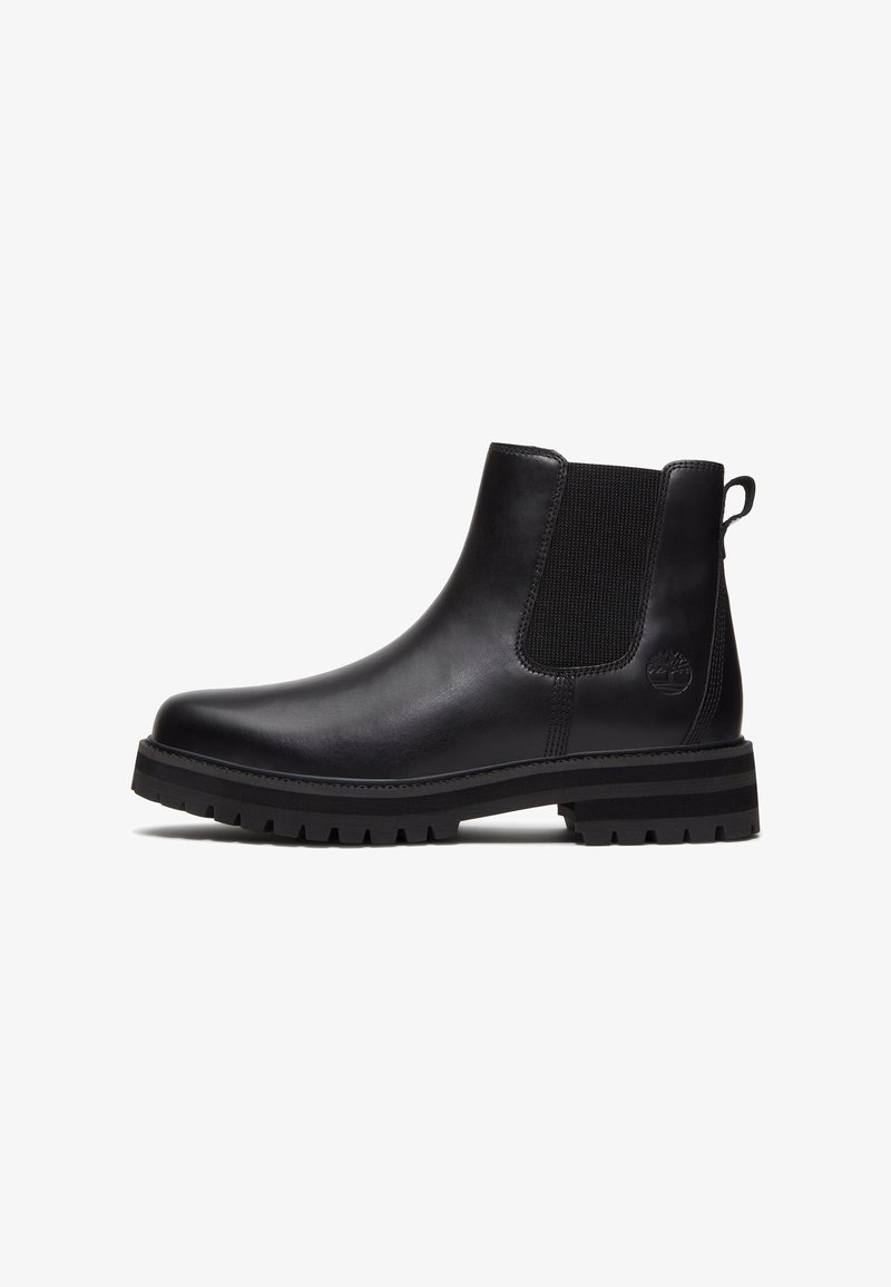Boots en cuir noir avec panneau latéral élastique, languette au talon, bout rond et semelle épaisse à crampons. Logo Timberland embossé près du talon.