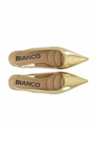 Tacones de charol dorado con punta afilada y diseño de corte lateral. Plantilla acolchada con el logo 'BIANCO' impreso en negro sobre fondo beige.