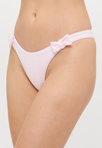 Roza spodnji del bikinija iz gladkega materiala, z dvema majhnima lokom na straneh in minimalističnim dizajnom.
