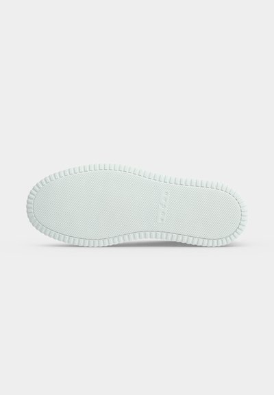 Semelle de chaussure en caoutchouc blanc avec motif antidérapant texturé et le nom de la marque "MORGAN" embossé au centre.