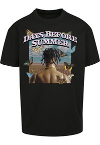 Black cotton t-shirt featuring a graphic print showing a person from the back surrounded by butterflies and the text "DAYS BEFORE SUMMER."