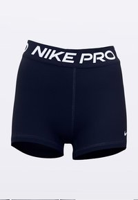 Marineblå Nike Pro træningsshorts med et hvidt elastisk linning med teksten "NIKE PRO". Glat materiale, tætsiddende design, længde til midt på låret.