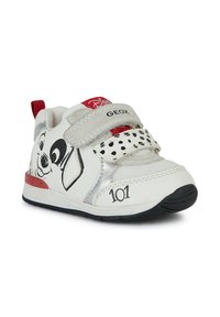 Scarpa bianca con pois neri, caratterizzata da un design di un cane dei cartoni animati. Cinturino in velcro, dettagli argentati e linguetta rossa sul tallone. Materiale morbido con rete testurizzata.