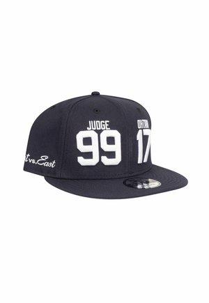 Navy blue snapback cap with white embroidered text: "JUDGE 99" and "ONTARIO 17." Features flat brim and logo on the underside.