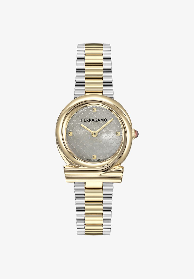 Zweifarben-Uhr aus Gold- und Silbermetall mit rundem Zifferblatt, strukturiertem silbrigem Muster, goldenen Akzenten und Markenlogo. Schweizer Herstellung.