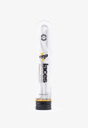 White round shoe laces packaged in a clear plastic tube with a black and yellow base. Features brand logo and product details on the tube.