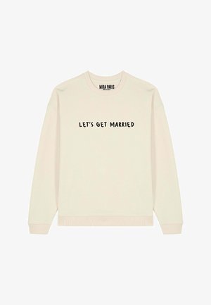 Roomkleurige sweatshirts gemaakt van katoen, met een losse pasvorm. De voorkant heeft zwarte tekst met de woorden "LATEN WE TRUIWEN." Geribbelde manchetten en zoom.