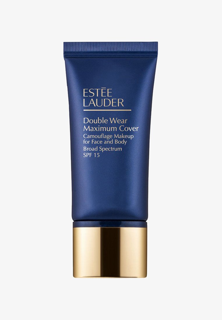 Donkerblauwe knijptube met een gouden basis. Het bevat witte tekst met de label "Double Wear Maximum Cover" en informatie over SPF 15.