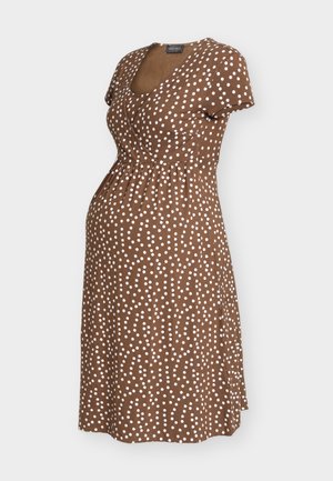 Ruskea äitiysmekko valkoisilla pilkuilla, lyhyillä hihoilla, V-pääntie ja kerätty vyötärö mukavaan istuvuuteen.