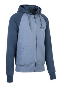 Giacca con cappuccio e zip in gradiente blu. Presenta maniche raglan, tasche frontali e coulisse regolabile. Realizzata in tessuto morbido e testurizzato.