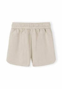 Shorts beige à taille élastique avec ourlet incurvé et coutures visibles, posés à plat sur un fond blanc.