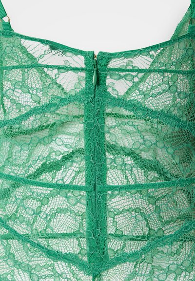 Roheline pitsist top, millel on lillemuster, reguleeritavad rihmad ja seljal tõmblukuga detail, tekstuurse ning läbipaistva disainiga.