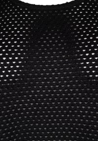 Tissu en maille noire avec de petits trous en forme de cœur et un grand cœur noir en satin cousu au centre.