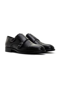 Zwarte leren dubbele monkstrap schoenen met een ronde neus, minimale stiksels en accenten in zilverkleurige gespen. Glad textuur en slank ontwerp.