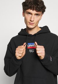 Levi's® RELAXED GRAPHIC - Sweatshirt com capuz - black