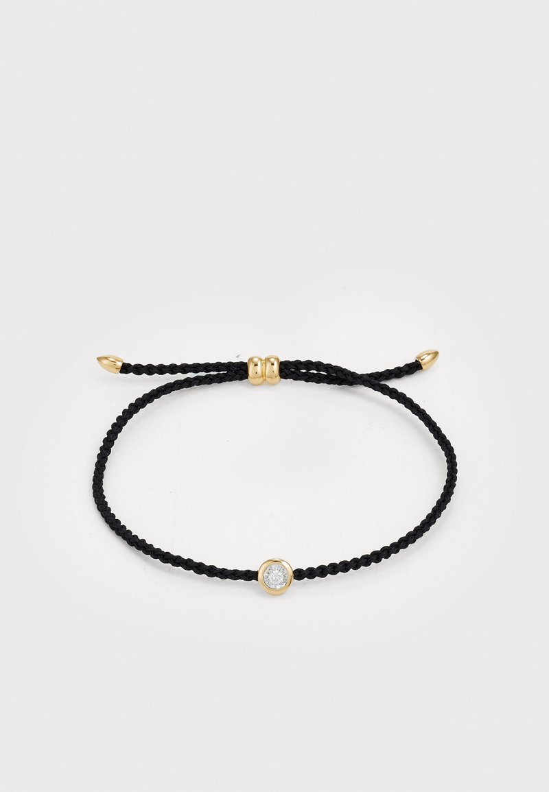 Juodas pintas virvės apyrankė su centriniu skaidriu gemstone, įstatytu į auksą, ir auksinės spalvos reguliuojamu užsegimu bei kraštais.