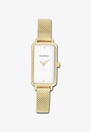 Montre rectangulaire en or avec un cadran blanc, présentant un design minimaliste, un bracelet en mailles et trois petits cadrans indiquant l'heure.