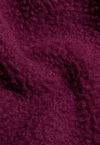 Tessuto morbido di un profondo colore viola con una superficie ricca e testurizzata. Il materiale sembra soffice e vellutato, con una leggera lucentezza.