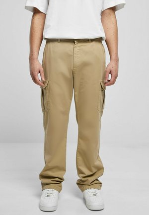 Khaki cargo pants with a relaxed fit, featuring side pockets and a smooth texture. Paired with white sneakers and a plain white t-shirt.