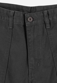 Ciemnoszare spodnie z płaskim pasem, jednym metalowym guzikiem i plisowanymi detalami z przodu. Materiał wydaje się trwały o drobnej teksturze.