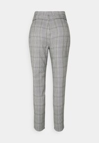 Grå rutiga byxor med slim fit, skräddarsydd midja och diskret rutmönster, med en mjuk textur och fållade manschetter.