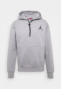 Felpa grigia in cotone con tasca frontale, cordino regolabile nero e logo Jordan nero sul lato sinistro del petto. Texture liscia, design informale.