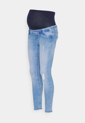 Zwangere skinny jeans in lichtblauwe denim met een zwarte stretchband, voorzien van distressed accenten en een taps toelopend ontwerp.
