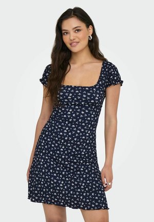 Marineblaue Blume-Kleid mit kurzen, rüschierten Ärmeln und quadratischem Ausschnitt. Eng anliegendes Oberteil, das in einen ausgestellten Rock übergeht. Kleines, weißes Blumenmuster.