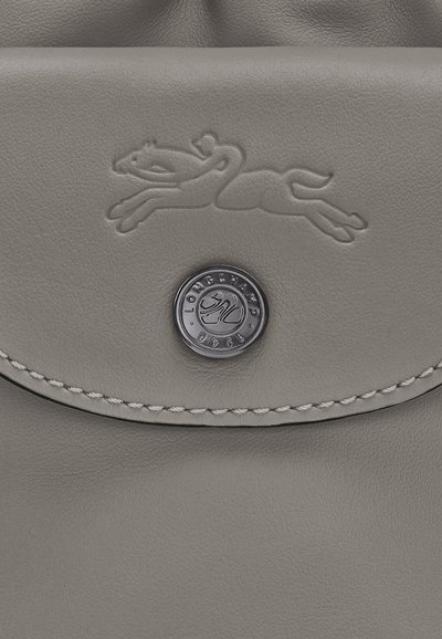 Gray leather bag featuring an embossed running horse design, a round metallic button with brand logo, and contrasting stitching detail.