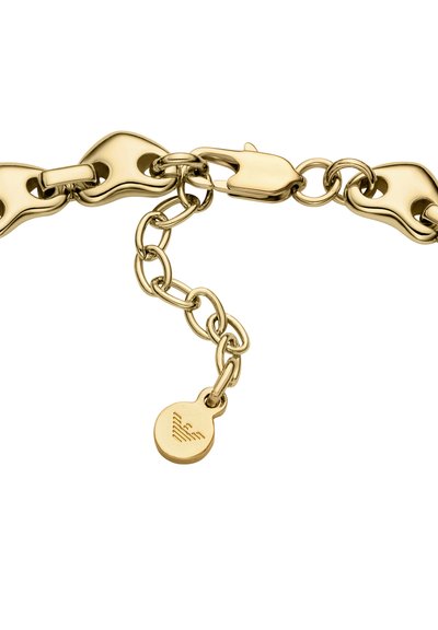 Zapestnica iz verižice z zlatim tonom, ki ima gladke, zaobljene povezave in vzmetno zaponko, ter okroglo obesek z detajlom logotipa.