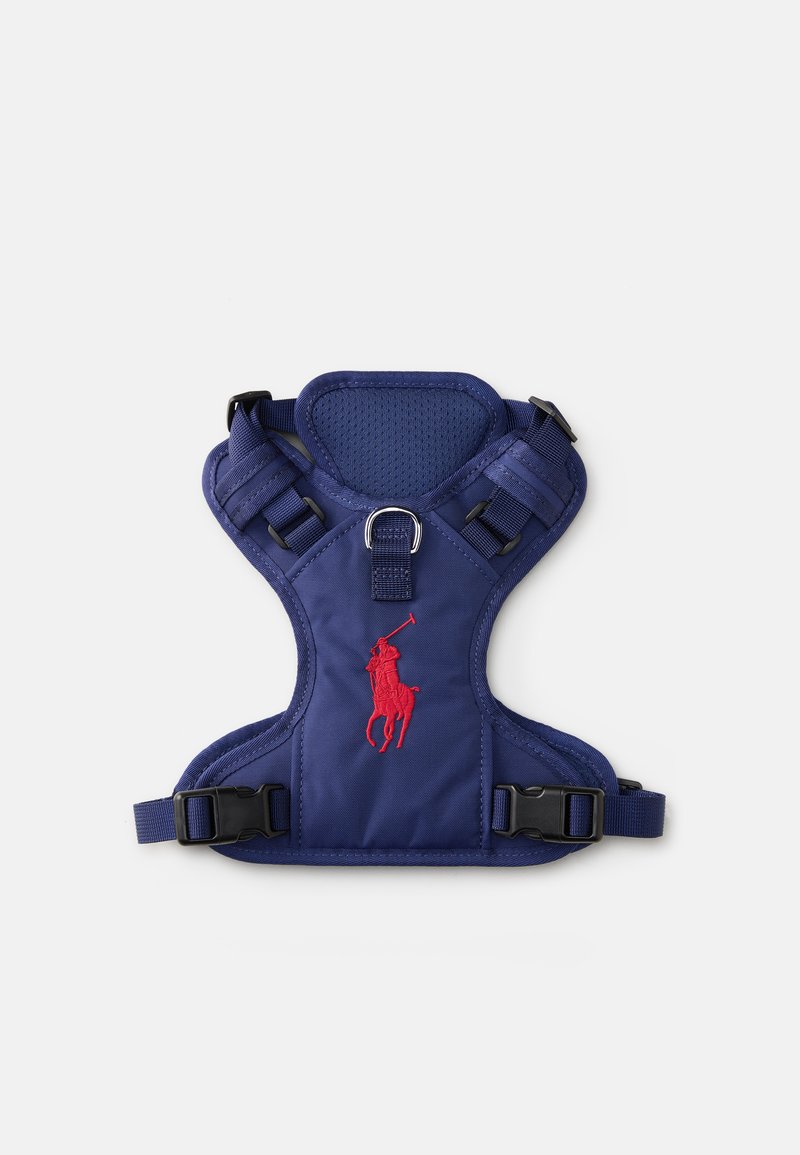 Navy pet harness with a padded design, adjustable straps, plastic buckles, and a red embroidered logo. Mesh panel for breathability.