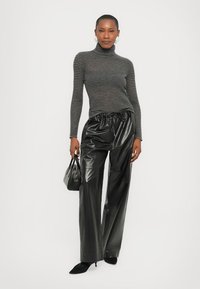 Black faux leather wide-leg pants with an elastic waistband, paired with a fitted gray ribbed turtleneck. Includes a small black handbag.