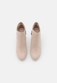 Beige Wildleder-Stiefeletten mit glatter Oberfläche, spitzem Zeh und seitlichem Reißverschluss. Entworfen für eine taillierte Silhouette.