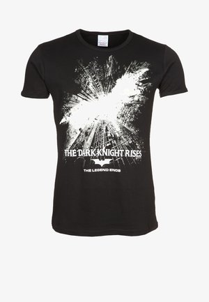 Black T-shirt with white bat symbol breaking through cityscape, text "The Dark Knight Rises" and "The Legend Ends" below.