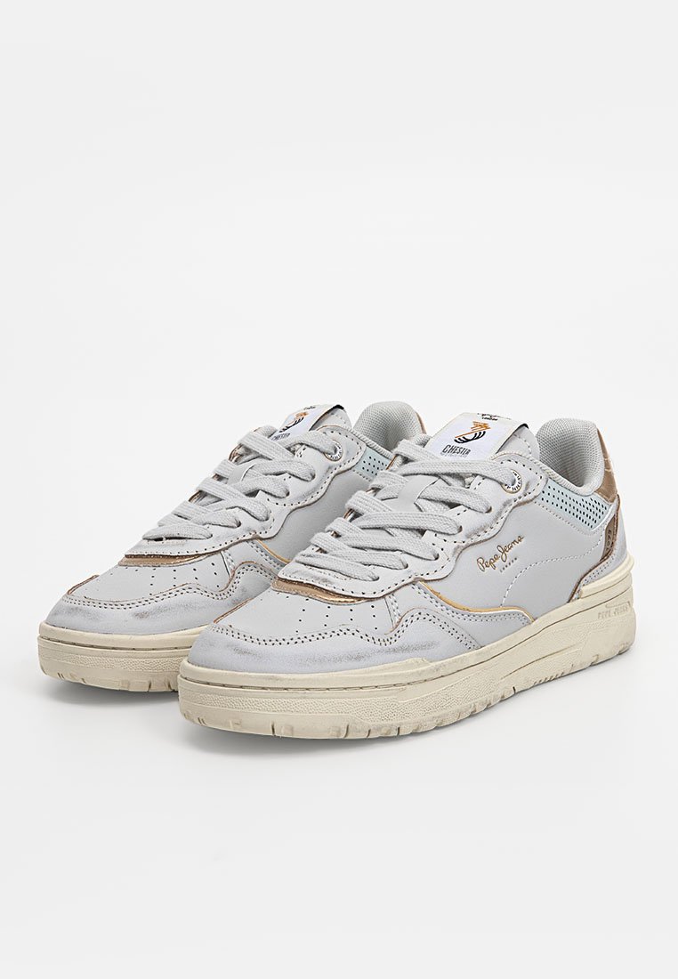 Graue Ledersneakers mit perforierten Akzenten, gepolstertem Kragen und beiger Laufsohle. Ausgestattet mit grauen Schnürsenkeln und einem goldenen Logo an der Seite.