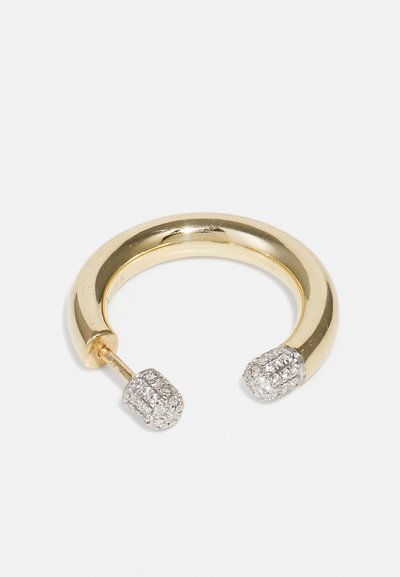 Gold hoop earring with a smooth, rounded design. Accented with two textured ends set with small, reflective stones.
