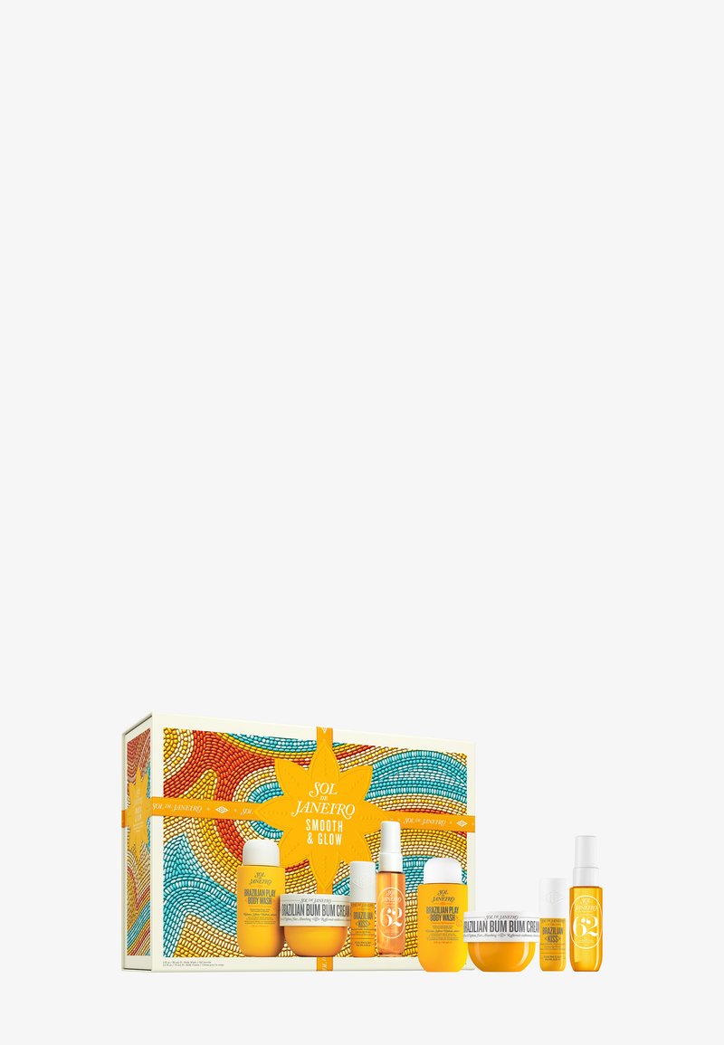 Conjunto de cuidado de la piel en color amarillo dentro de una caja decorativa, con un diseño de estrellas; incluye varios recipientes y botellas de diferentes formas y tamaños.