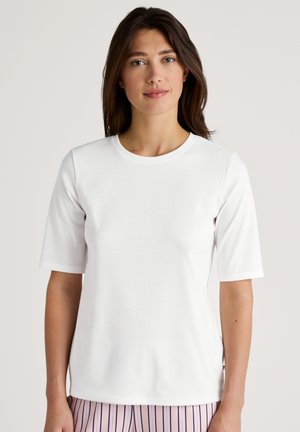 White short-sleeve t-shirt with a round neckline and a smooth texture; features side slits for ease of movement.