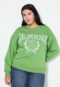 Zelená mikina se grafickým potiskem s nápisem "CALIFORNIA", volejbalem a vavřínovými akcenty. Měkká tkanina s uvolněným střihem.