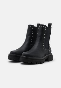 Black leather ankle boots with studded accents, elastic side panels, and chunky rubber soles, featuring a smooth texture and rounded toe.