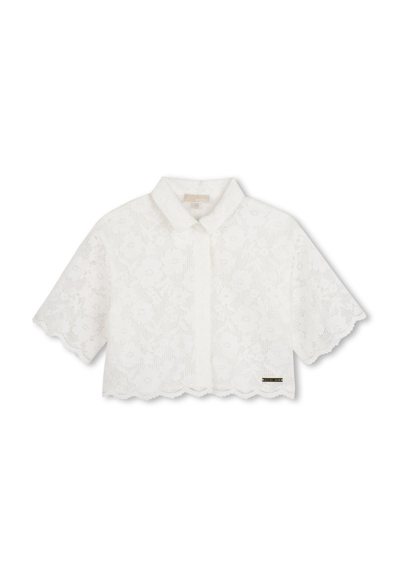 Biała, skrócona bluzka z kwiatowym wzorem koronki, falowanym dołem i krótkimi rękawami. Posiada klasyczny kołnierzyk i delikatne oznakowanie marki.