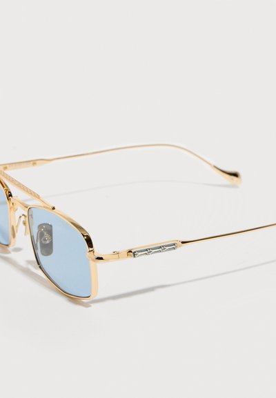 Gold-framed rectangular sunglasses with light blue lenses and thin arms, featuring a decorative silver detail on the temples.