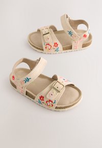 Sandales pour enfants beige avec boucles et brides ajustables, décorées de motifs floraux brodés colorés, sur un fond neutre.