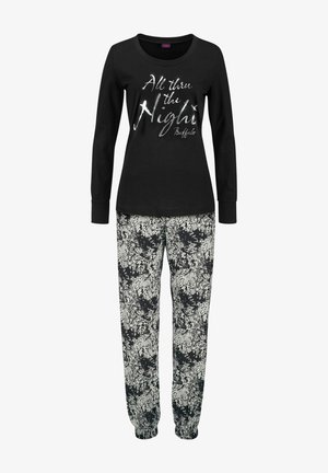 Black long-sleeve top with silver text "All thru the Night," paired with loose-fitting floral print pants in black and white.