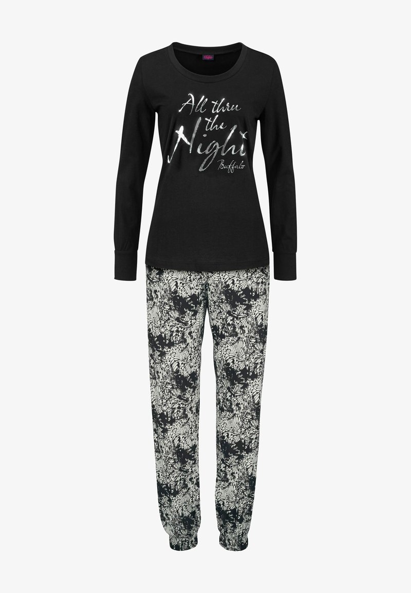 Black long-sleeve top with silver text "All thru the Night," paired with loose-fitting floral print pants in black and white.