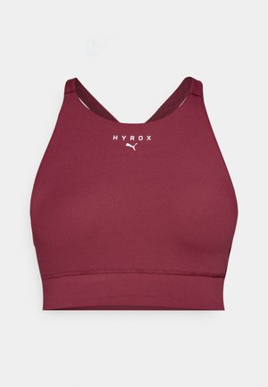 Μπορντό αθλητικό σουτιέν με σχέδιο racerback, κατασκευασμένο από ελαφρύ ύφασμα και με λευκό λογότυπο στη μπροστινή πλευρά. Απαλή υφή.