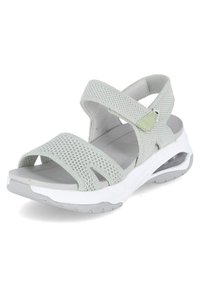 Sandales gris clair avec des brides tricotées, bout ouvert et fermeture velcro réglable. Semelle amortissante avec un accent de talon translucide.