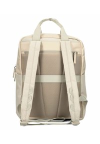 Mochila beige con respaldo de malla acolchada, correas ajustables, dos asas superiores, bolsillo exterior con cremallera y diseño elegante y minimalista.
