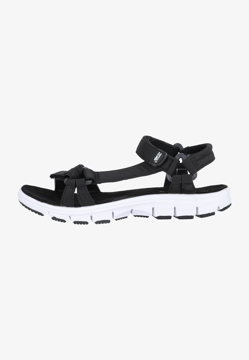 Svart sandal med ovandel i tyg och justerbara remmar, med en vit och svart dämpad sula med texturerat mönster.