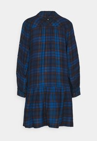 Blå och svart rutigt flanellklänning med långa ärmar, insydd midja och knappp detaljer på ärmarna. Broderade detaljer på baksidan.